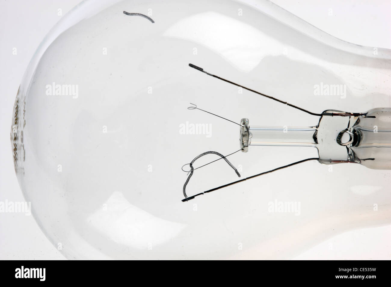 Electrical light bulb, torn, damaged glowing filament. Stock Photo
