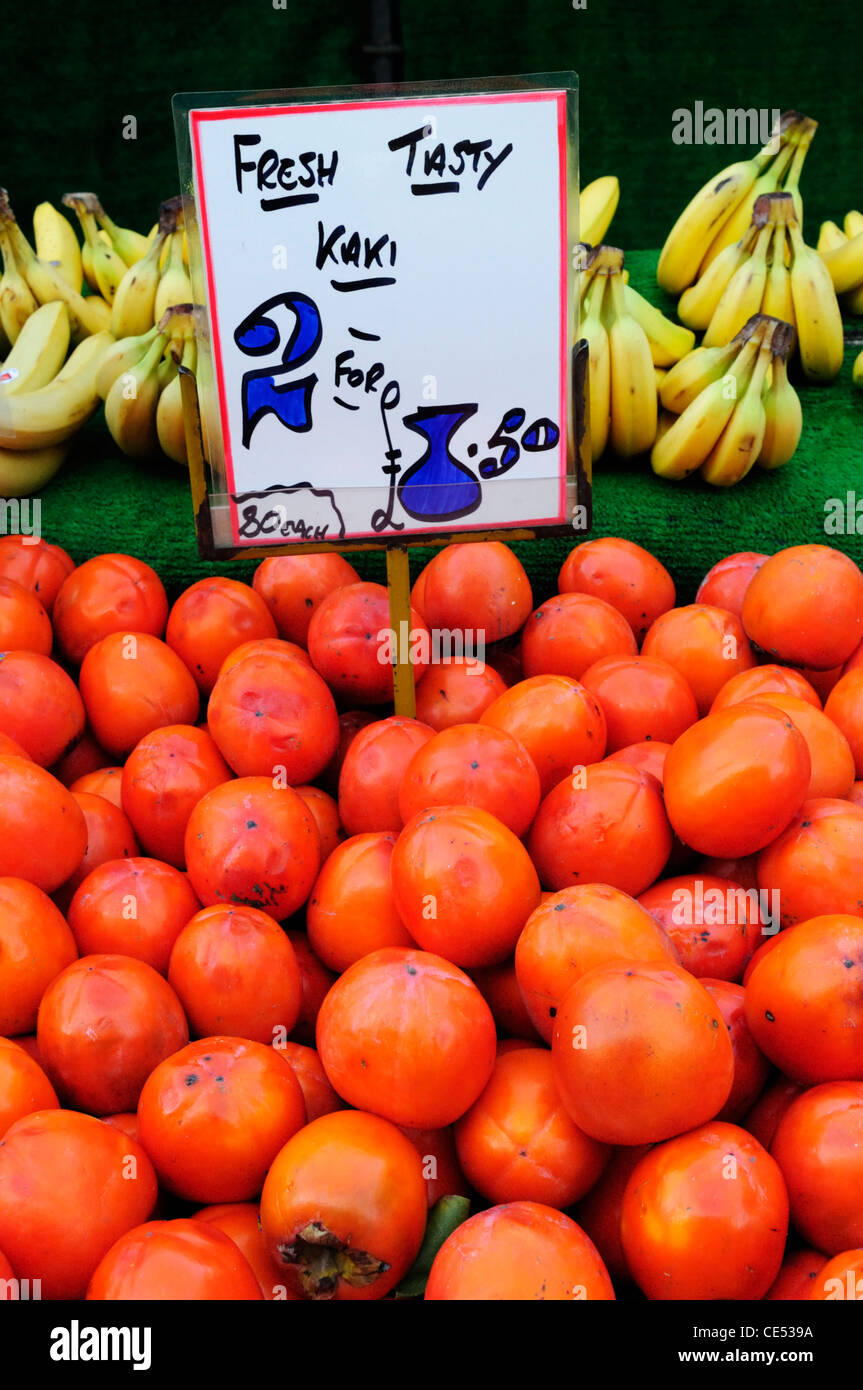 Kaki or Hachiya Persimmon Fruit for sale on the Market, Cambridge, England, UK Stock Photo