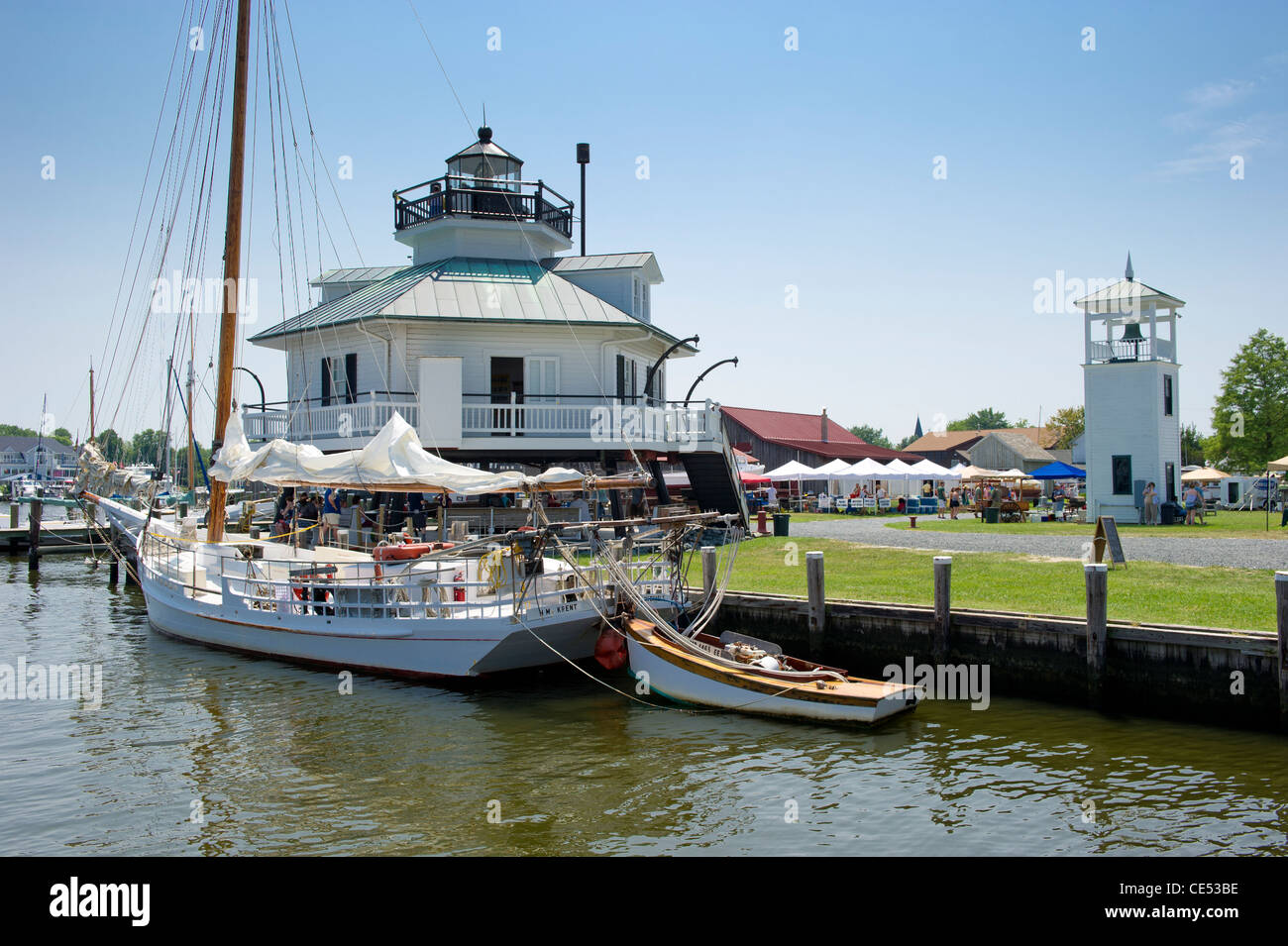 Boat docked in front of festival at Chesapeake Maritime Museum in St. Michaels MD Stock Photo