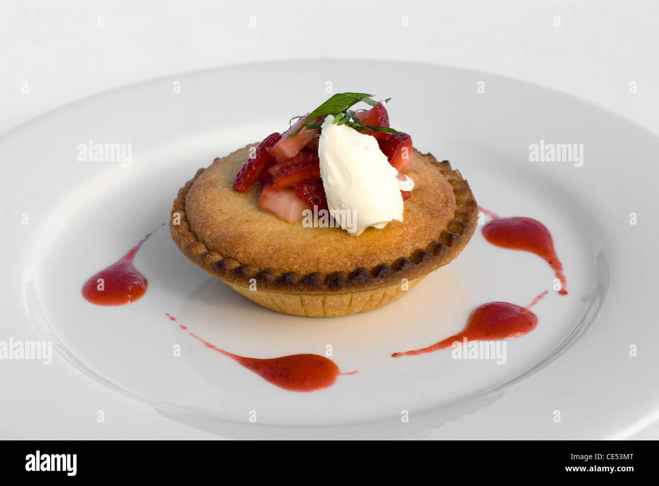 Frangipane Tart with Crème Fraîche and Strawberry Coulis Stock Photo