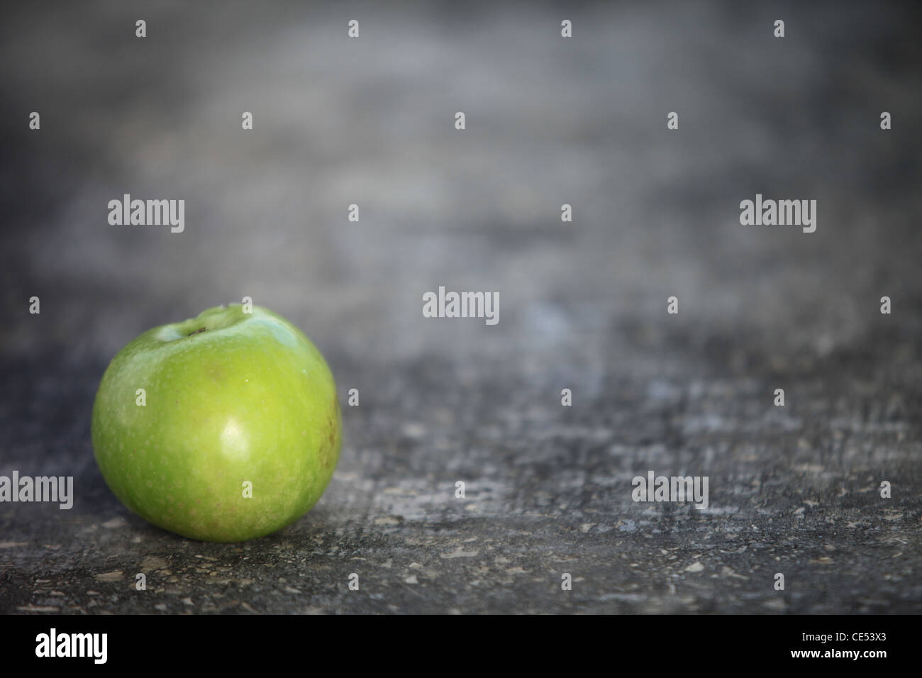 green fresh juicy apple is on the invoice table Stock Photo