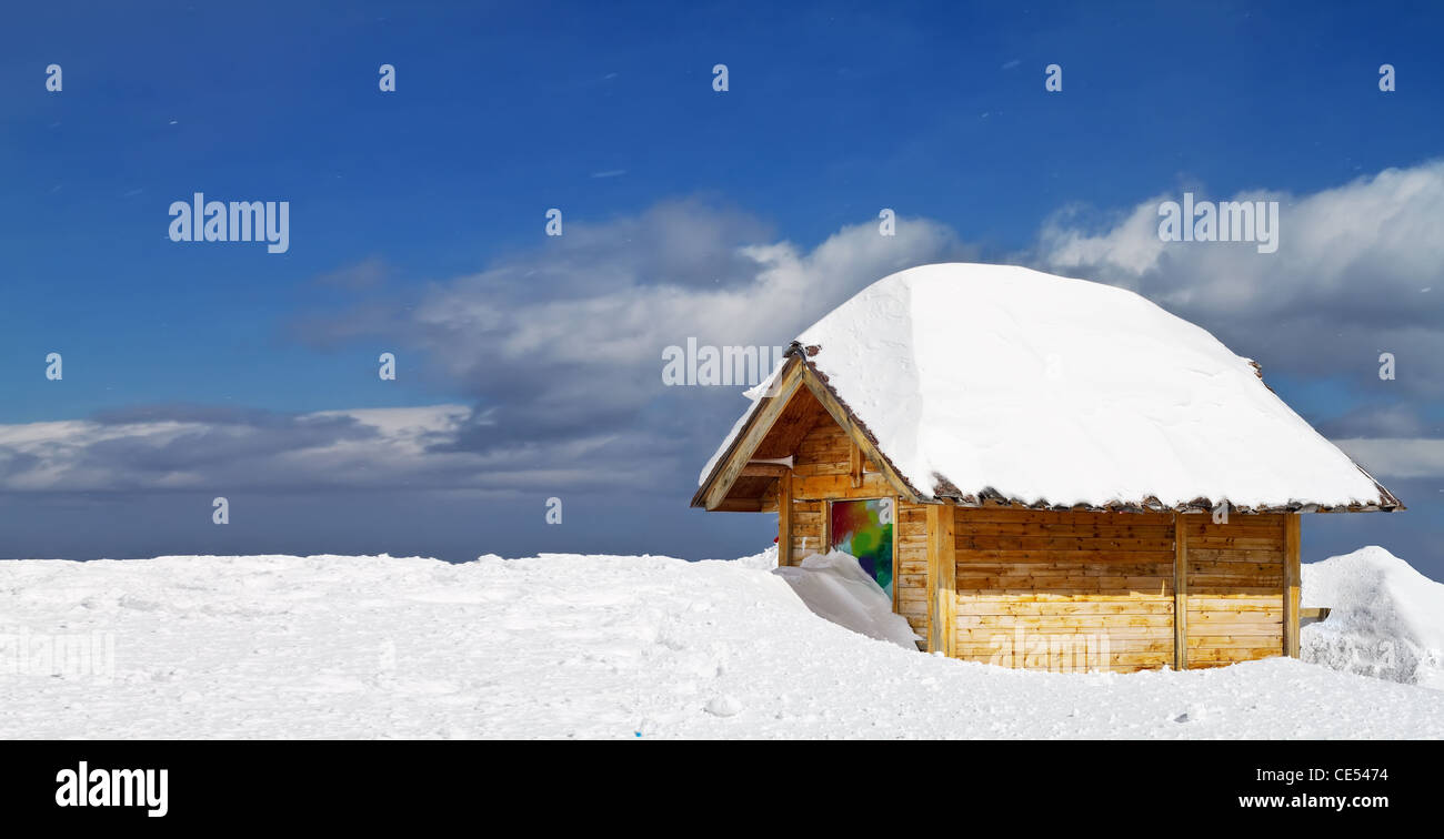 Wooden cottage on peak of Snow Mountain Stock Photo