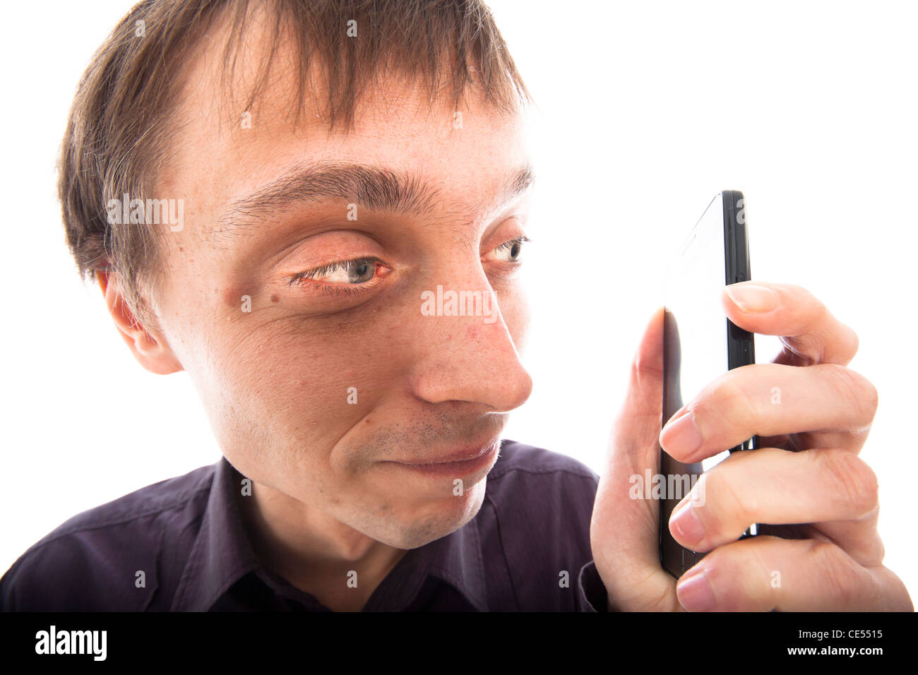 Ugly weirdo man looking at cellphone, isolated on white background. Stock Photo