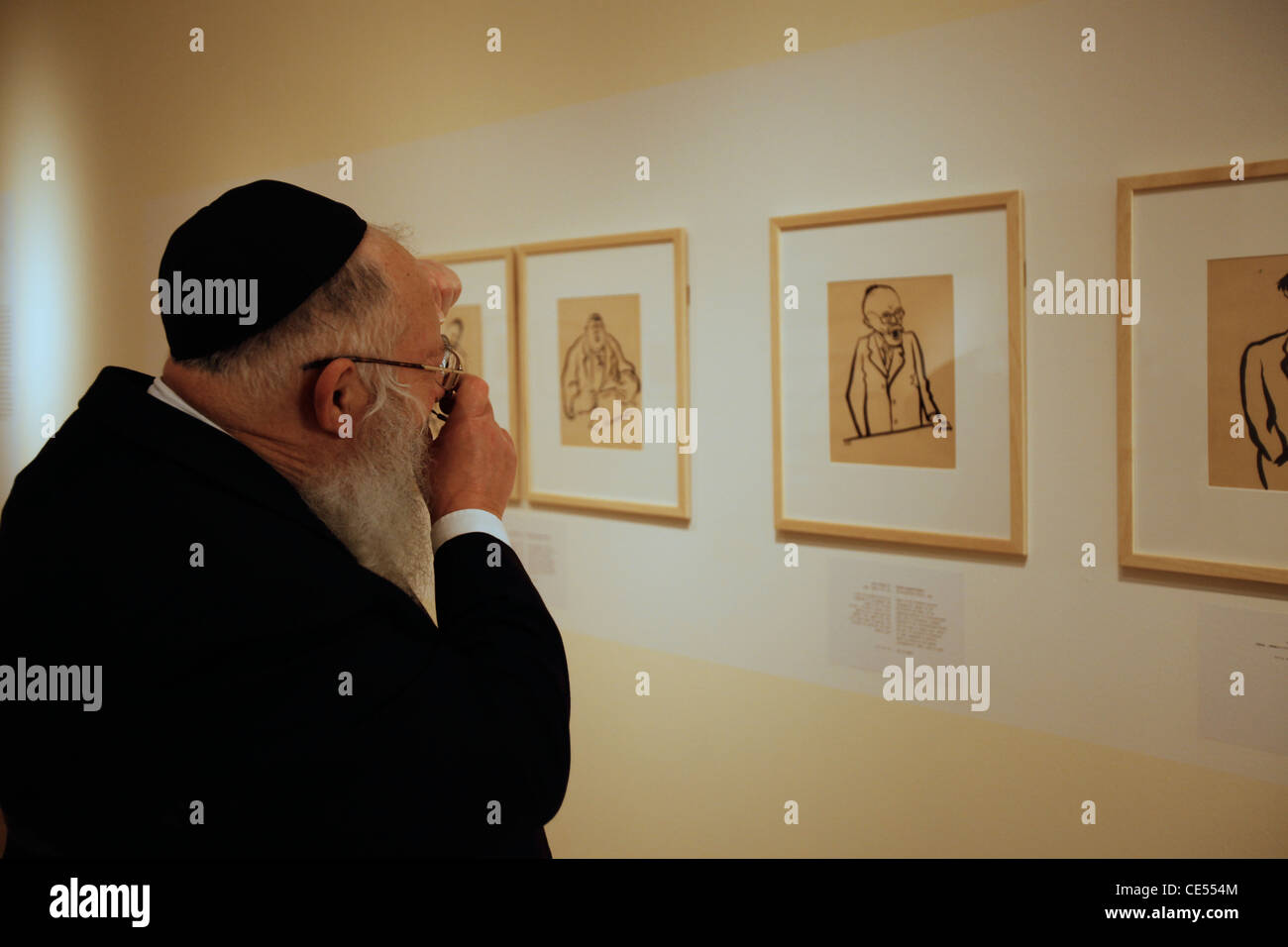 An Orthodox Religious Jew visiting a drawing exhibition by concentration camp prisoners in Yad Vashem museum in Jerusalem Israel Stock Photo