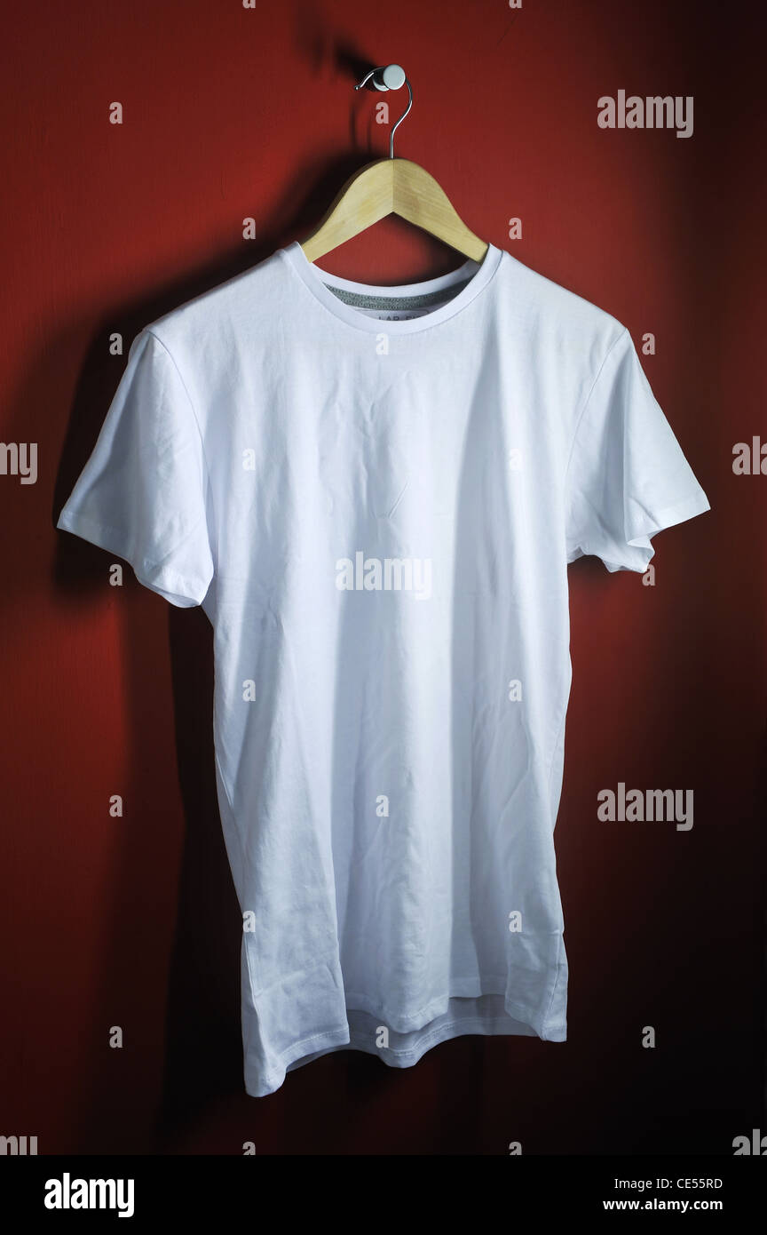 https://c8.alamy.com/comp/CE55RD/a-white-t-shirt-on-a-wooden-coat-hanger-bright-red-background-CE55RD.jpg