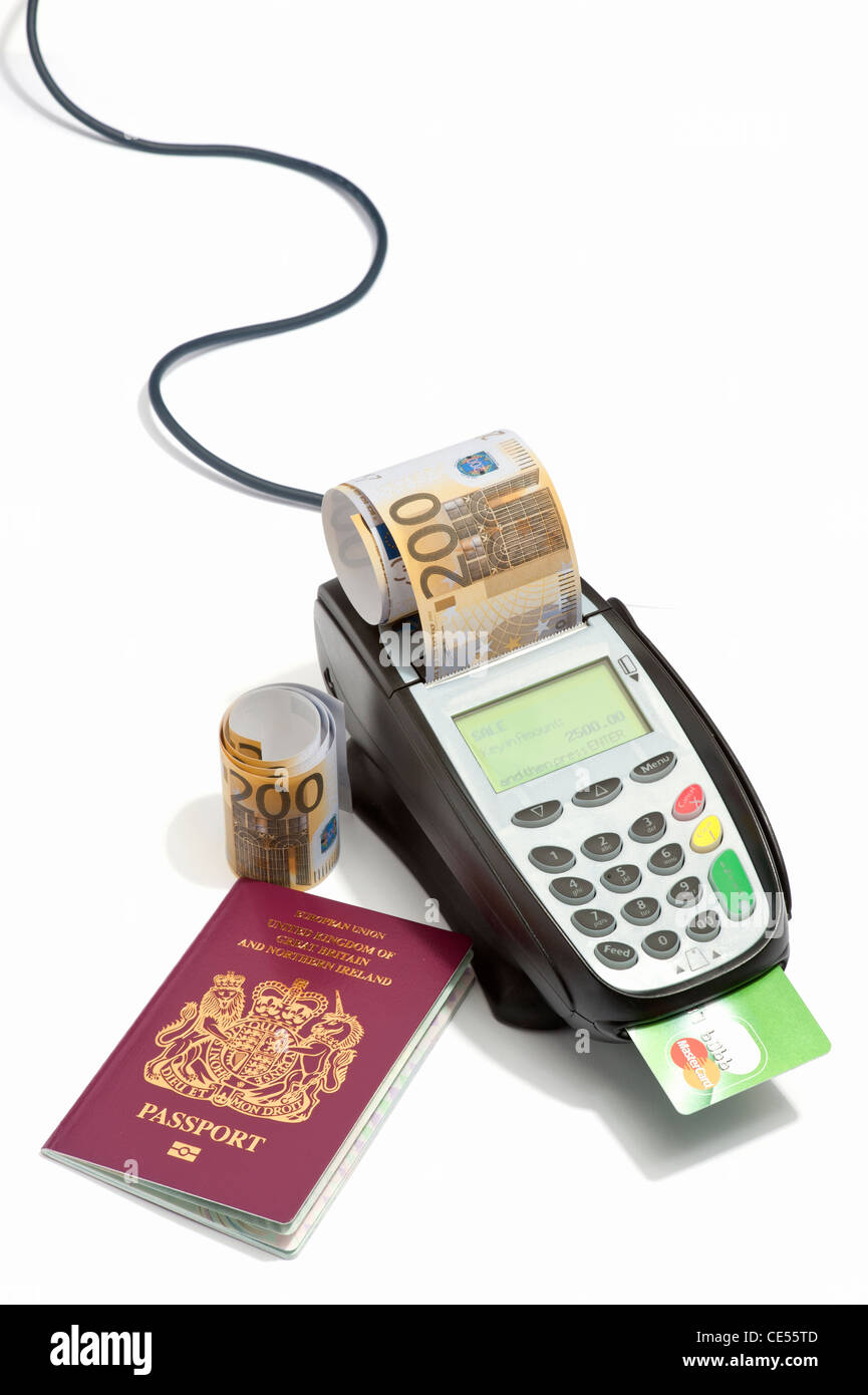 A British passport and a credit card machine dispensing euro bank notes ...