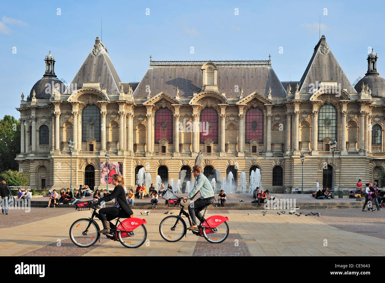 The Palais des Beaux-Arts de Lille / Lille Palace of Fine Arts and tourists riding rental bikes of V'Lille, France Stock Photo