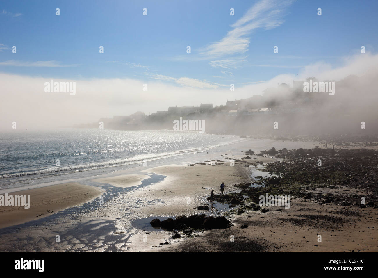 Quiet beach with sea mist on the headland on the Cornish south coast
