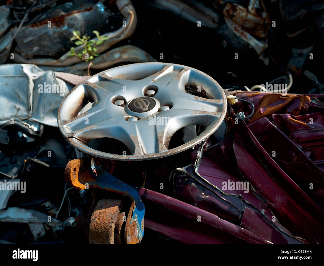 wheel trim broken in car scrapyard Stock Photo