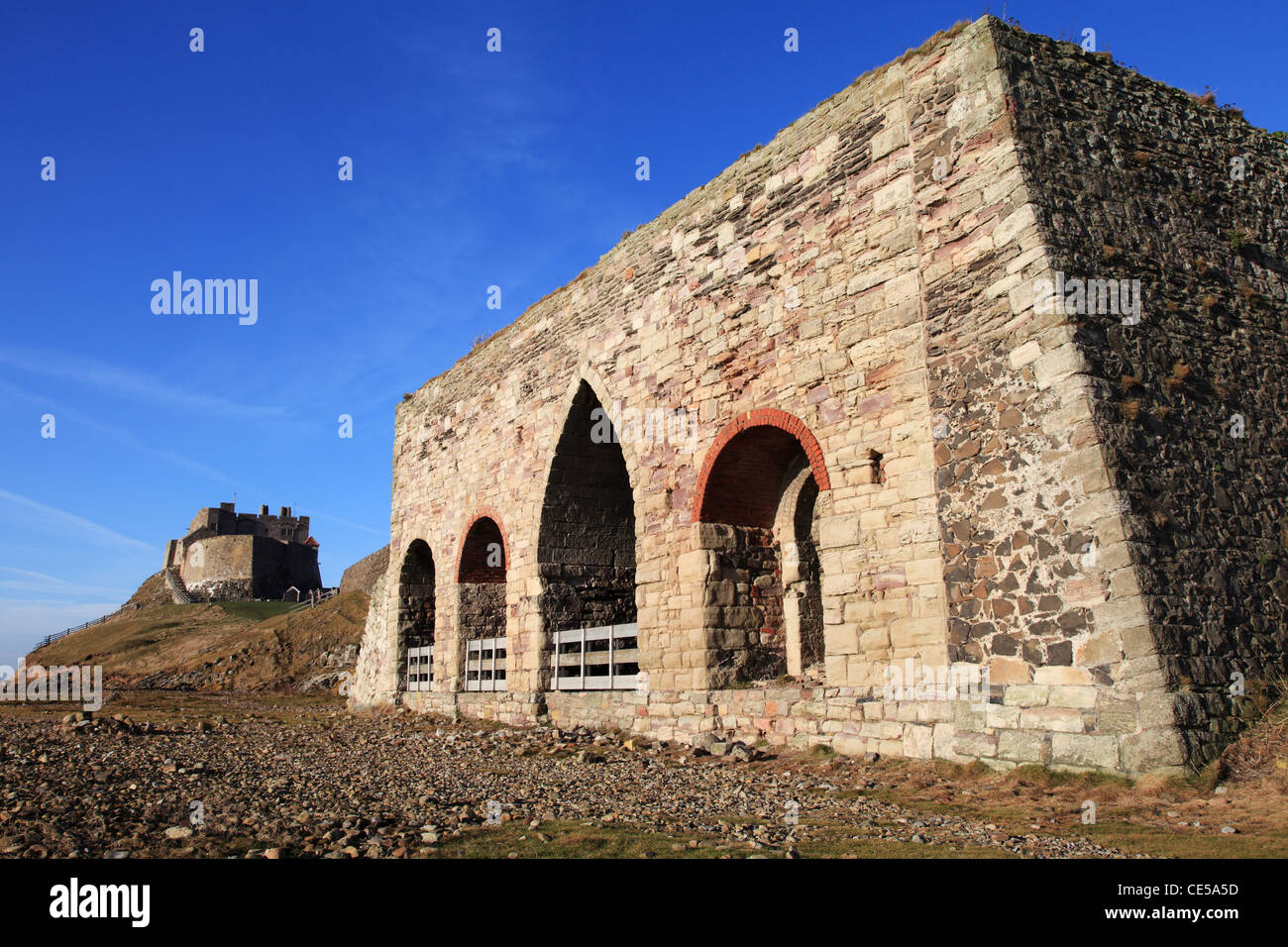 Lime kilns and castle Holy Island, north east England UK Stock Photo