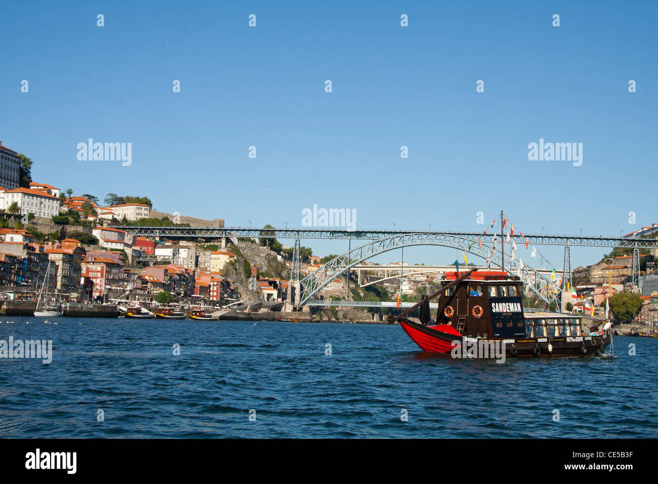 Sandeman Barco rabelo on the Douro river with D Luis Iron brigde, Porto and Vila Nova De Gaia on the background Stock Photo