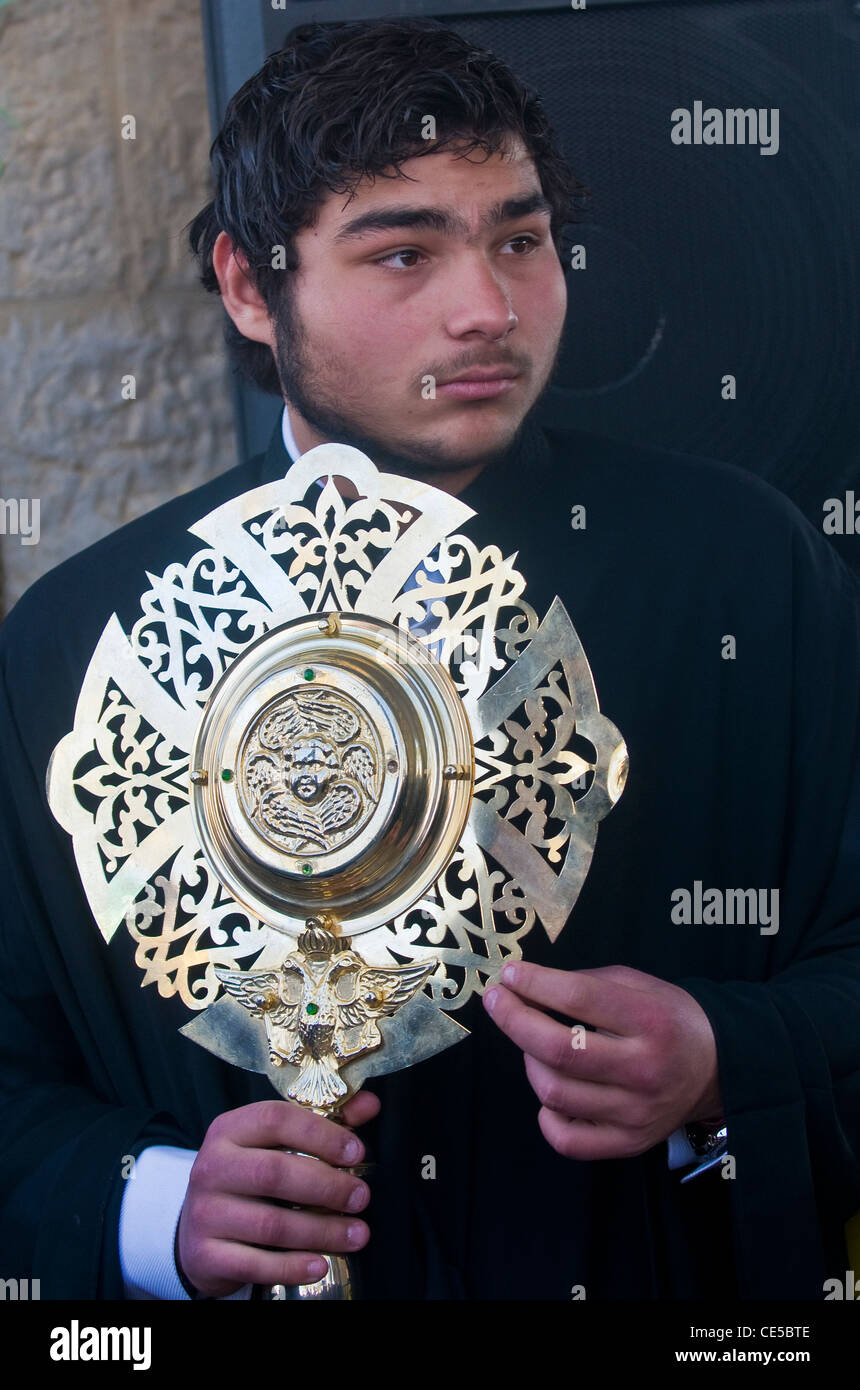 Greek orthodox monk participates in the baptizing ritual during the
