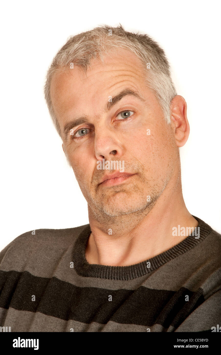 Man looks with pulled up eyebrow directly into the camera Stock Photo