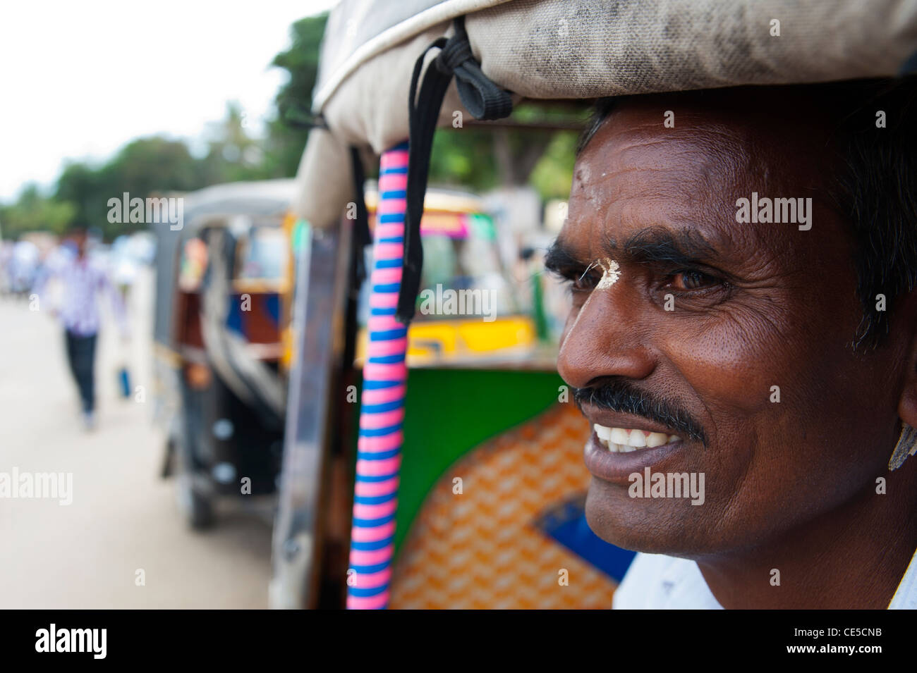 Rickshaw driver waiting for passengers at Halebeedu town, Karnataka, India Stock Photo