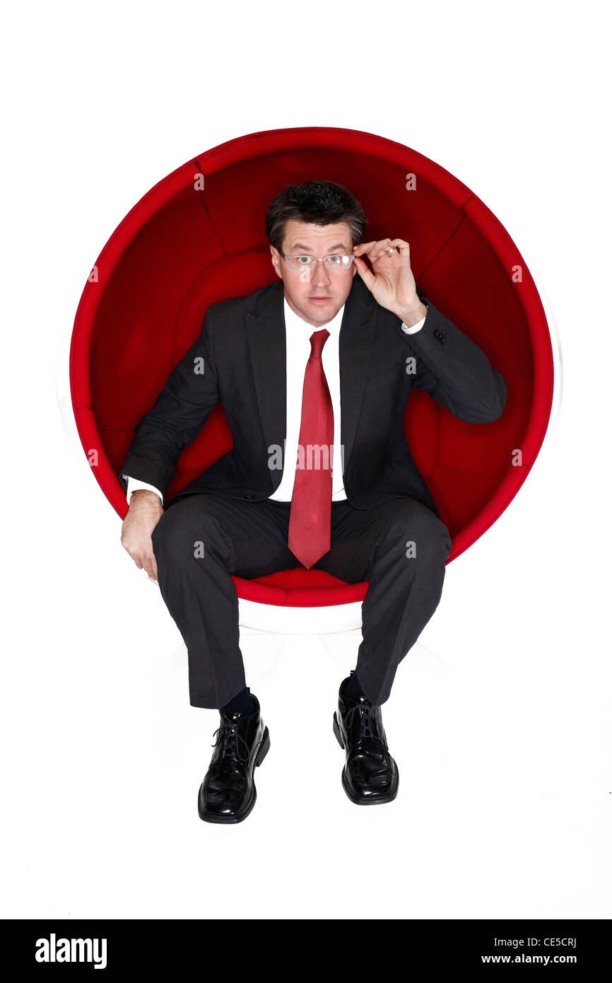 Portrait of a man in a retro ball chair Stock Photo
