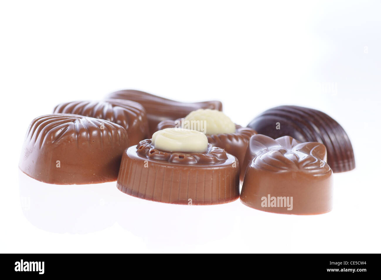 chocolate pralines on white background. Delicious dark and milk