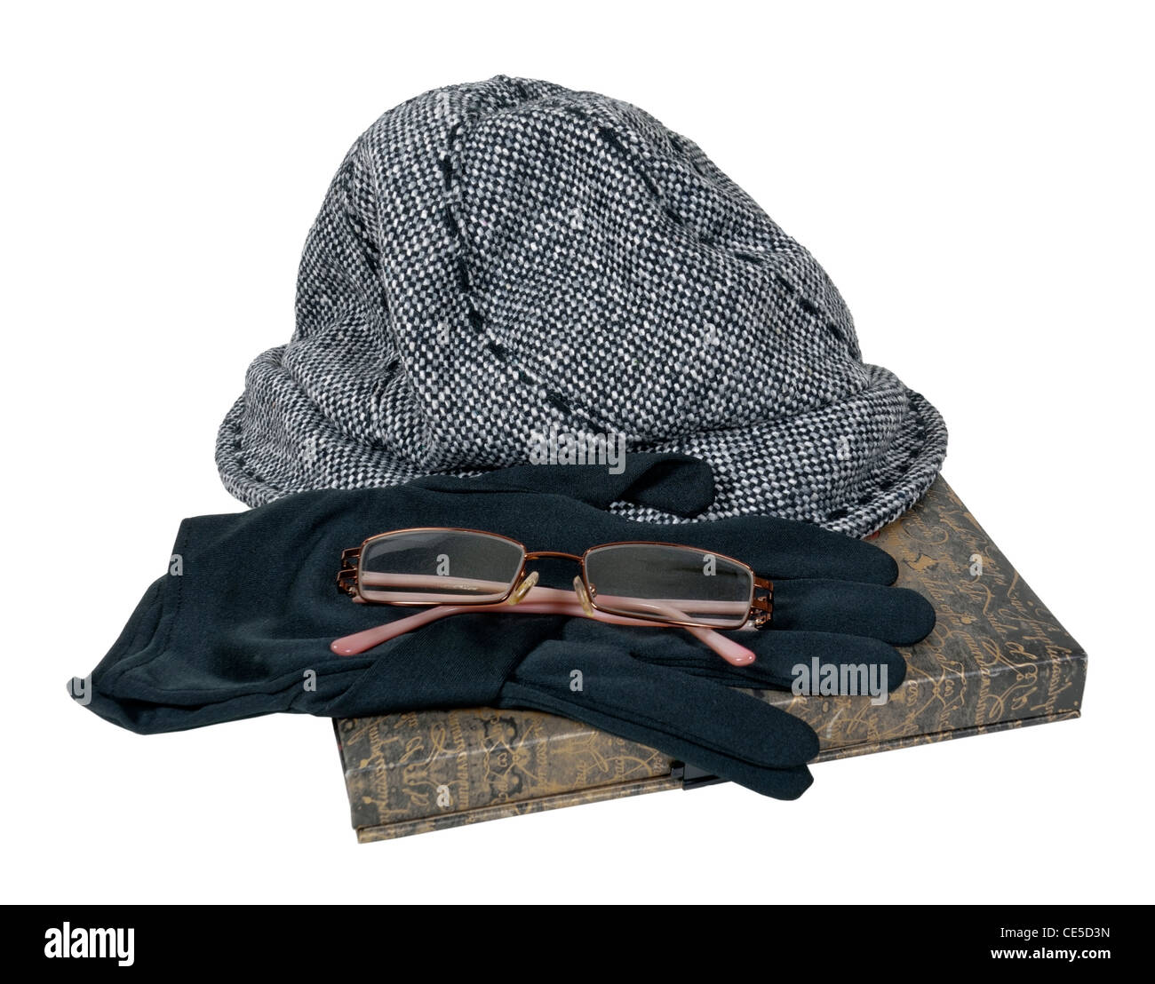 Tweed hat with black gloves and glasses on a book - path included Stock Photo