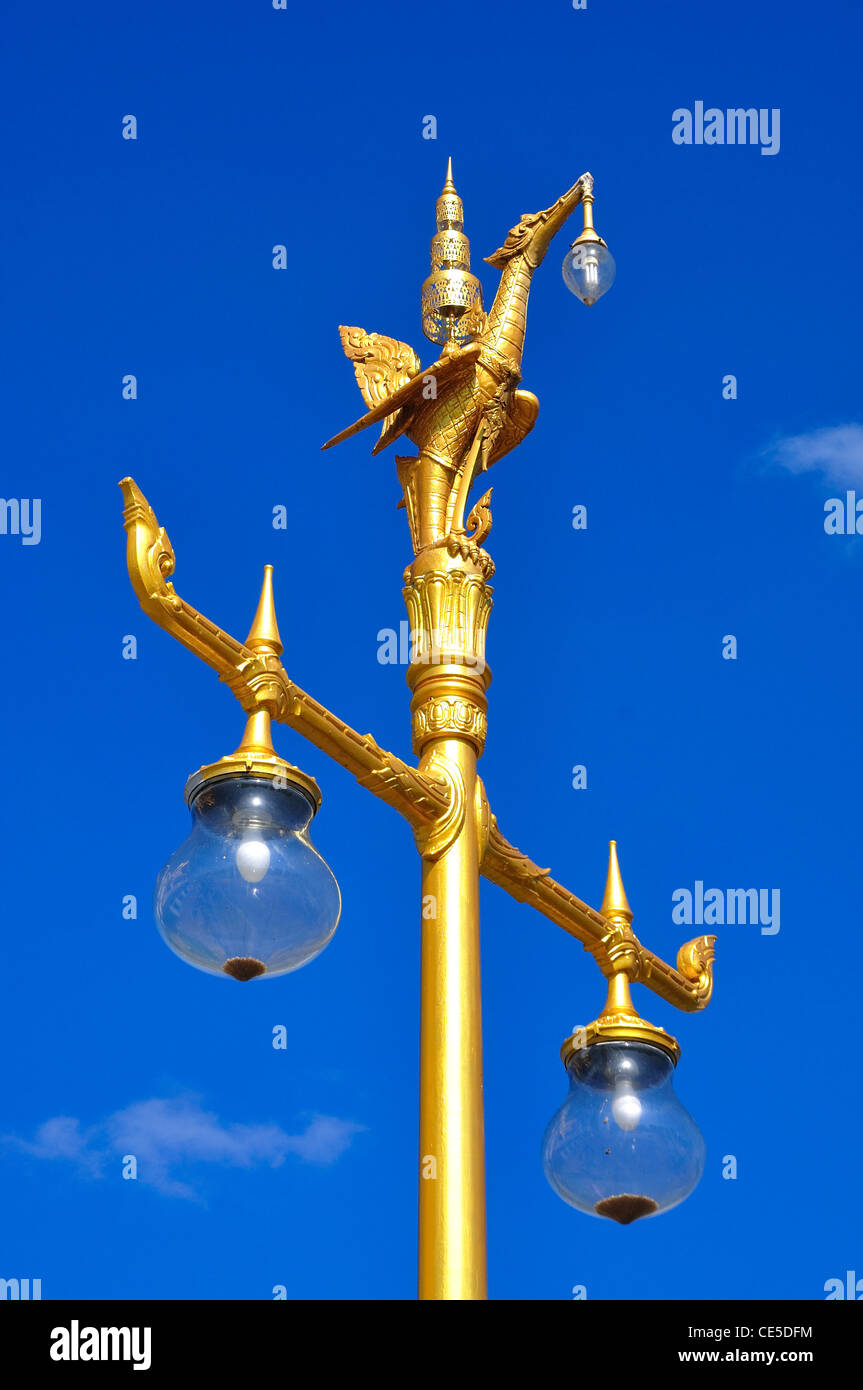 goldcolored lamp post standing in the blue sky Stock Photo Alamy