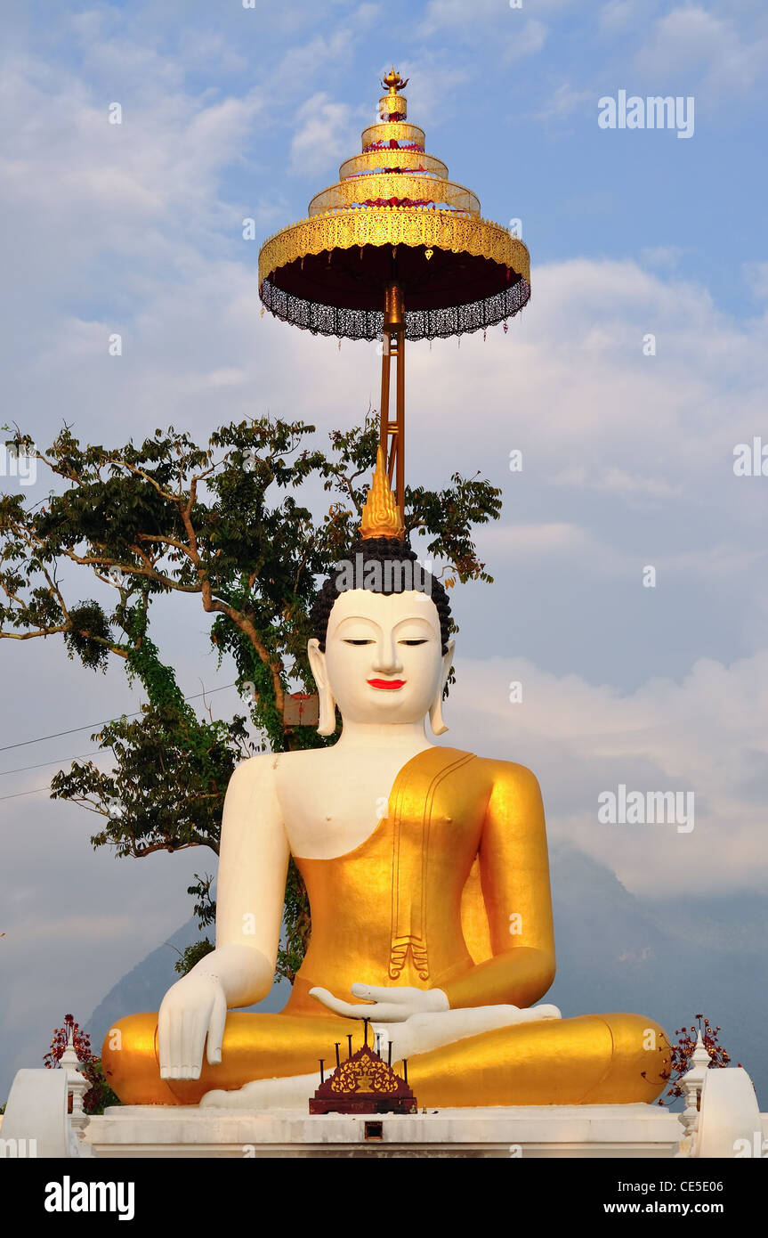 Gold buddha with tiered umbrella Stock Photo Alamy