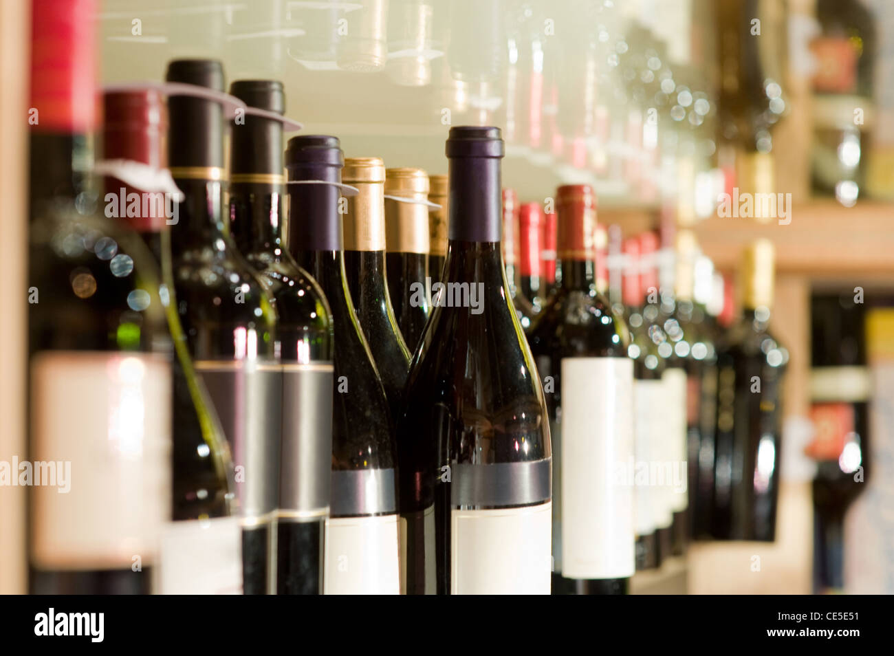 A selection of wine bottles on a shelf Stock Photo