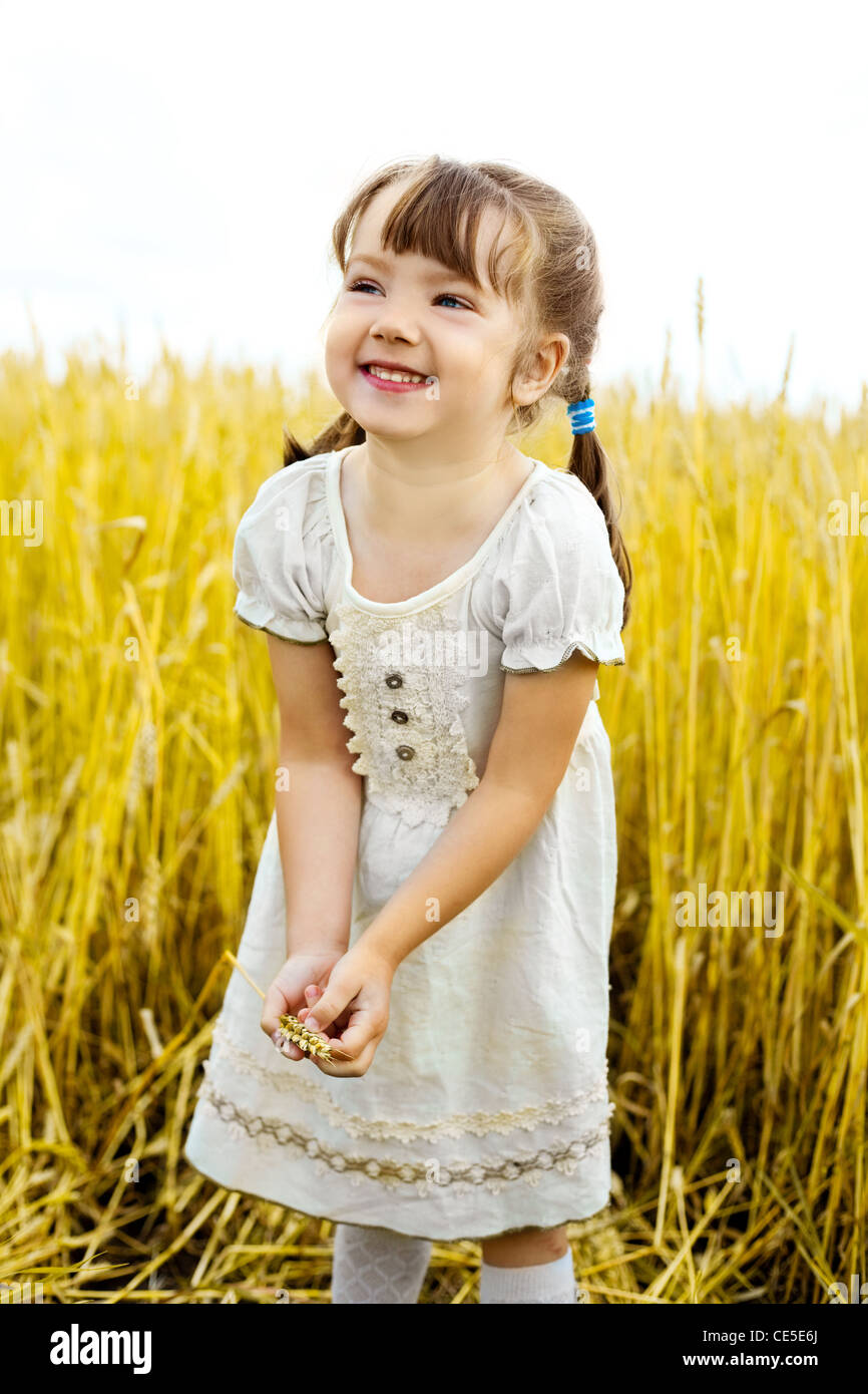 cute happy little girl in the wheat field Stock Photo - Alamy
