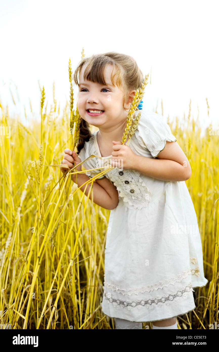 cute happy little girl in the wheat field Stock Photo - Alamy