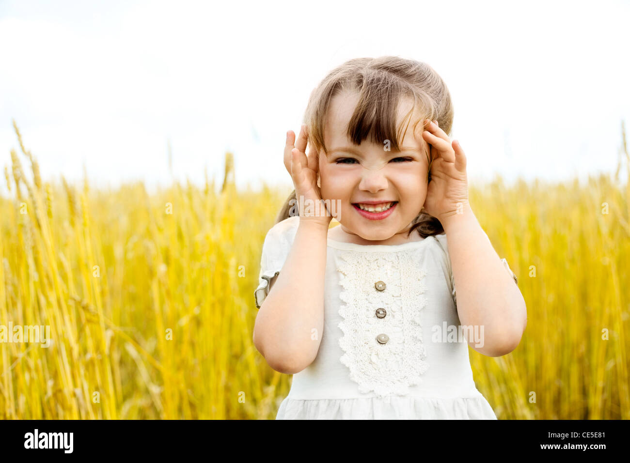 cute happy little girl in the wheat field Stock Photo - Alamy