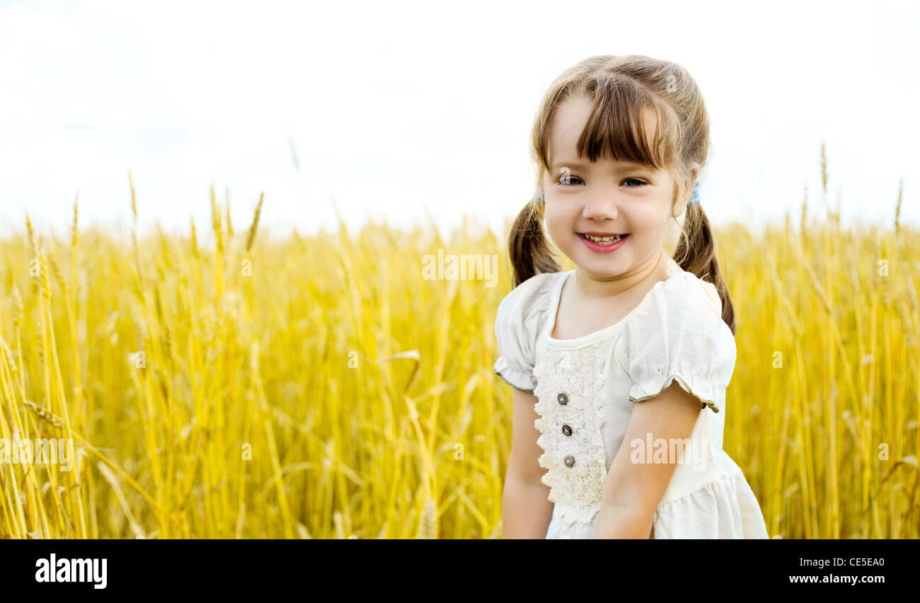 cute happy little girl in the wheat field Stock Photo - Alamy