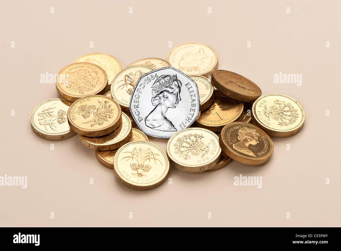 A pile of UK £coins with a 50p coin Stock Photo