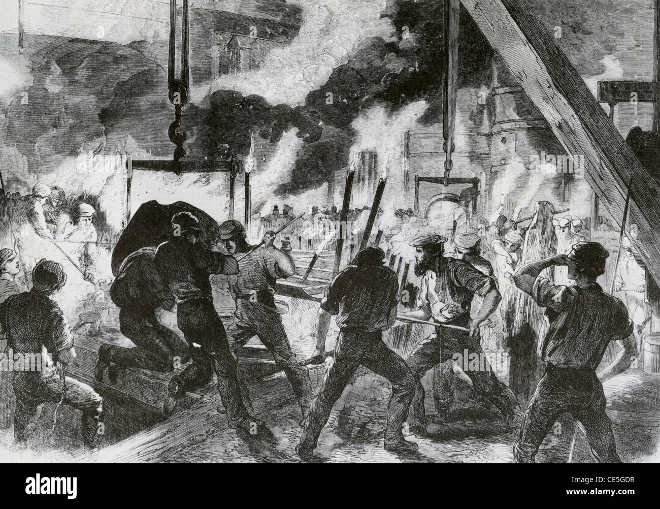 IRONWORKERS at the Canal Works in Poplar, south London, in 1863 casting a cylinder for  steam ship Stock Photo