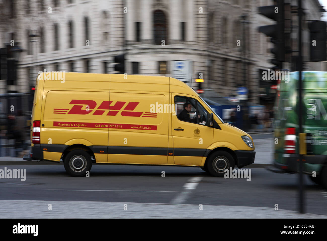 a DHL van traveling along a road in London Stock Photo