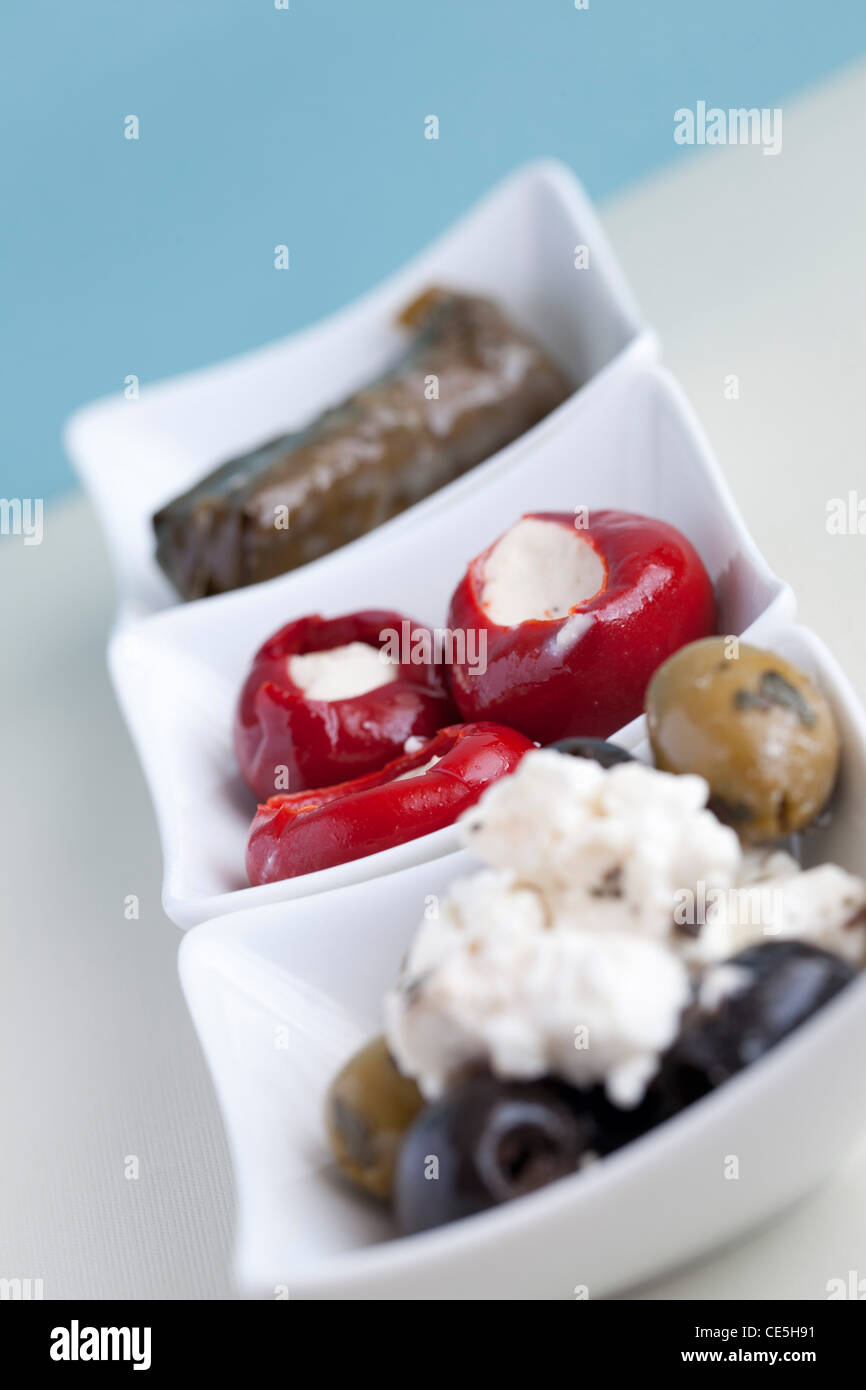 Mezze with olives, feta cheese, stuffed vine leaves & stuffed peppers Stock Photo