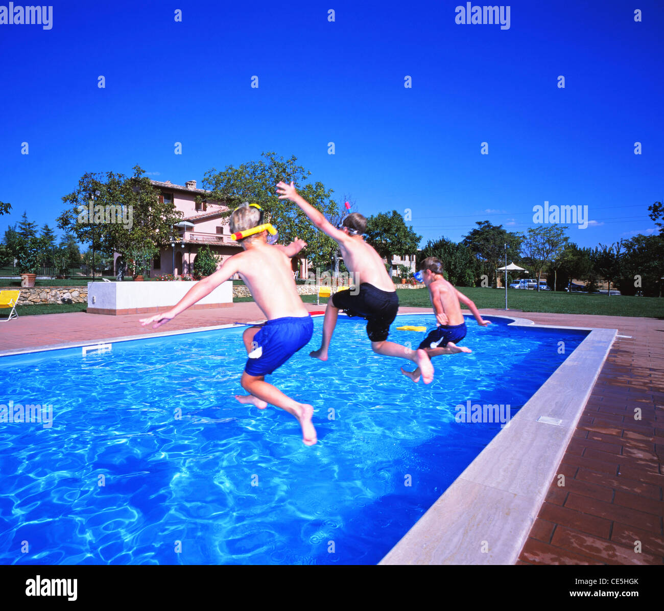 Three people jumping swimming pool hi-res stock photography and images ...