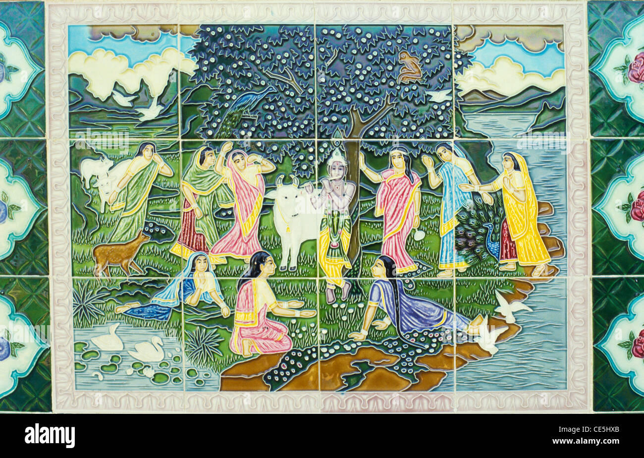 Lord Krishna playing flute and gopis on glazed ceramic tiles India Stock Photo