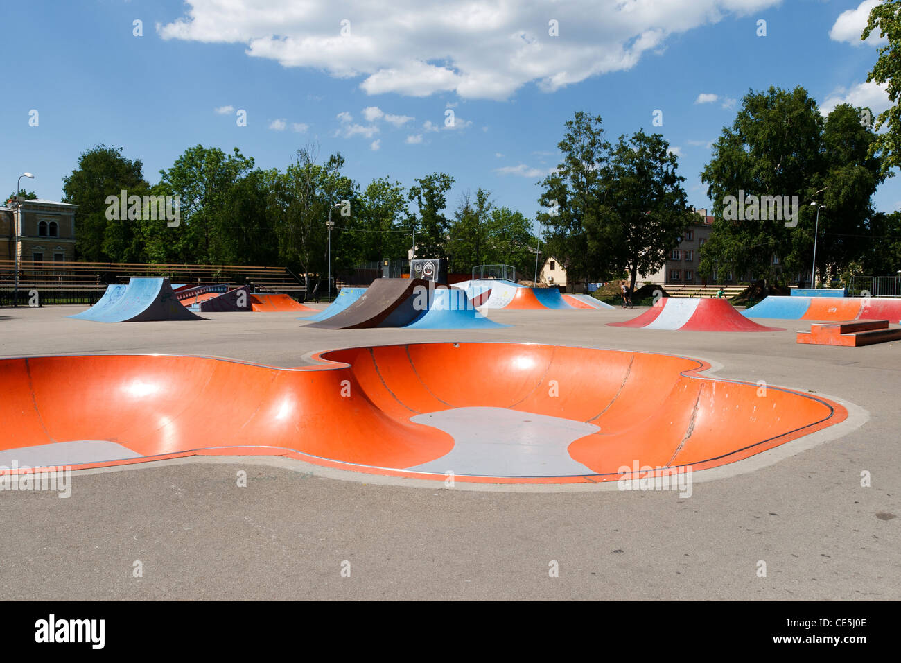 Empty skatepark with colorful ramps in sunny day Stock Photo - Alamy