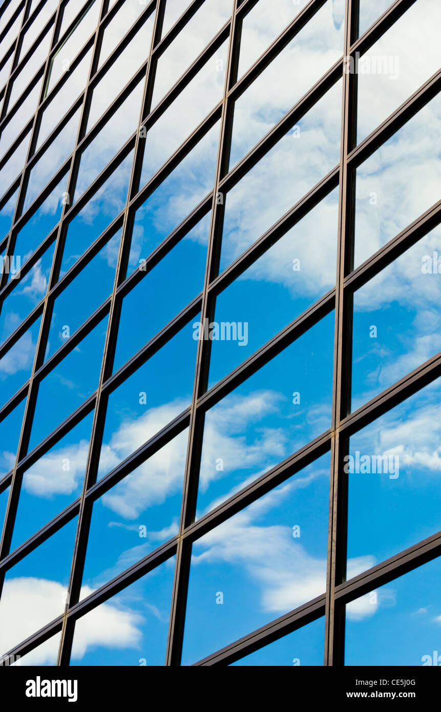 A Glass Building Reflecting the Blue Sky and Clouds Stock Photo - Alamy