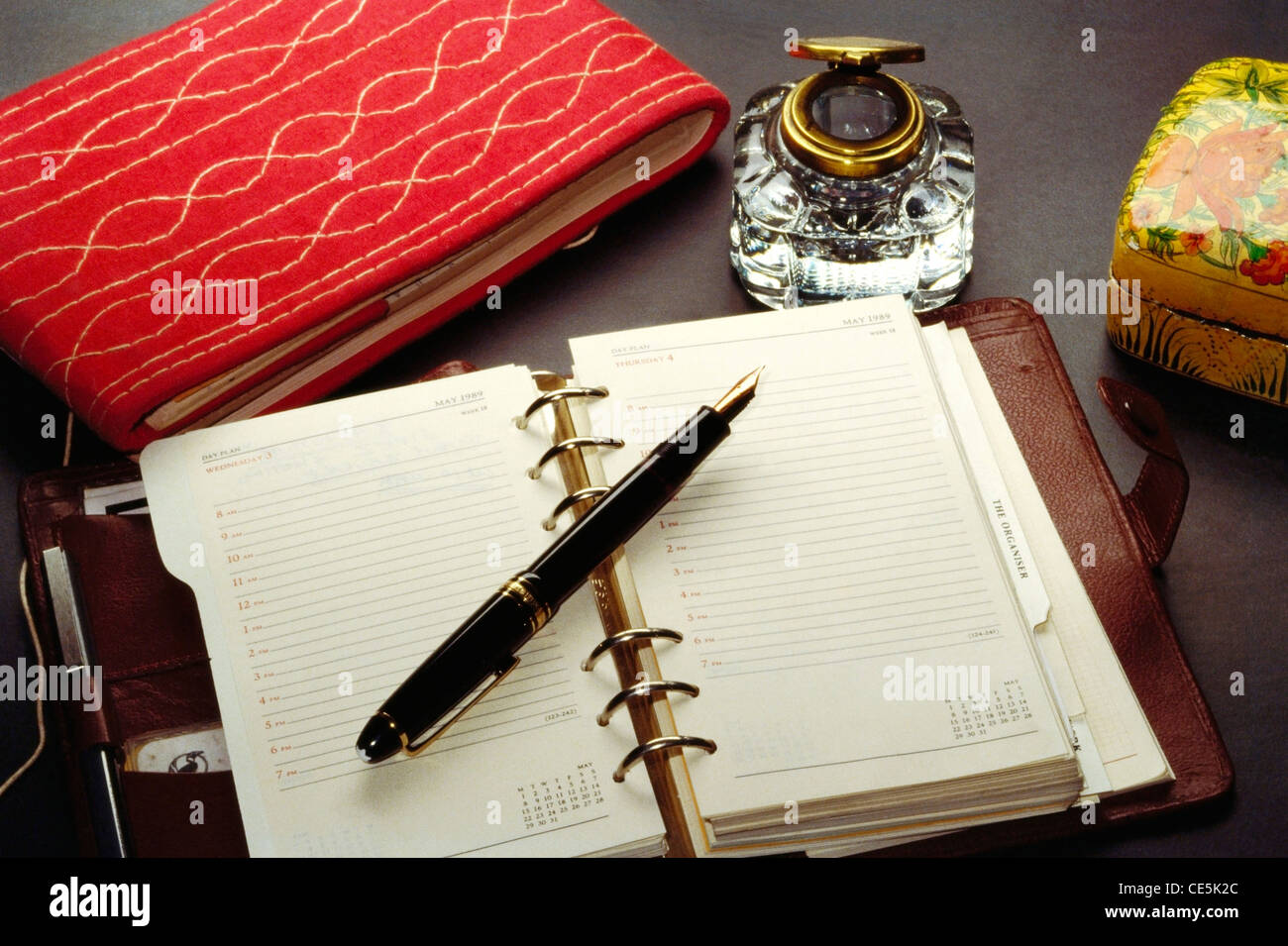 Ink pen on open diary and ink pot and bahi khata indian traditional