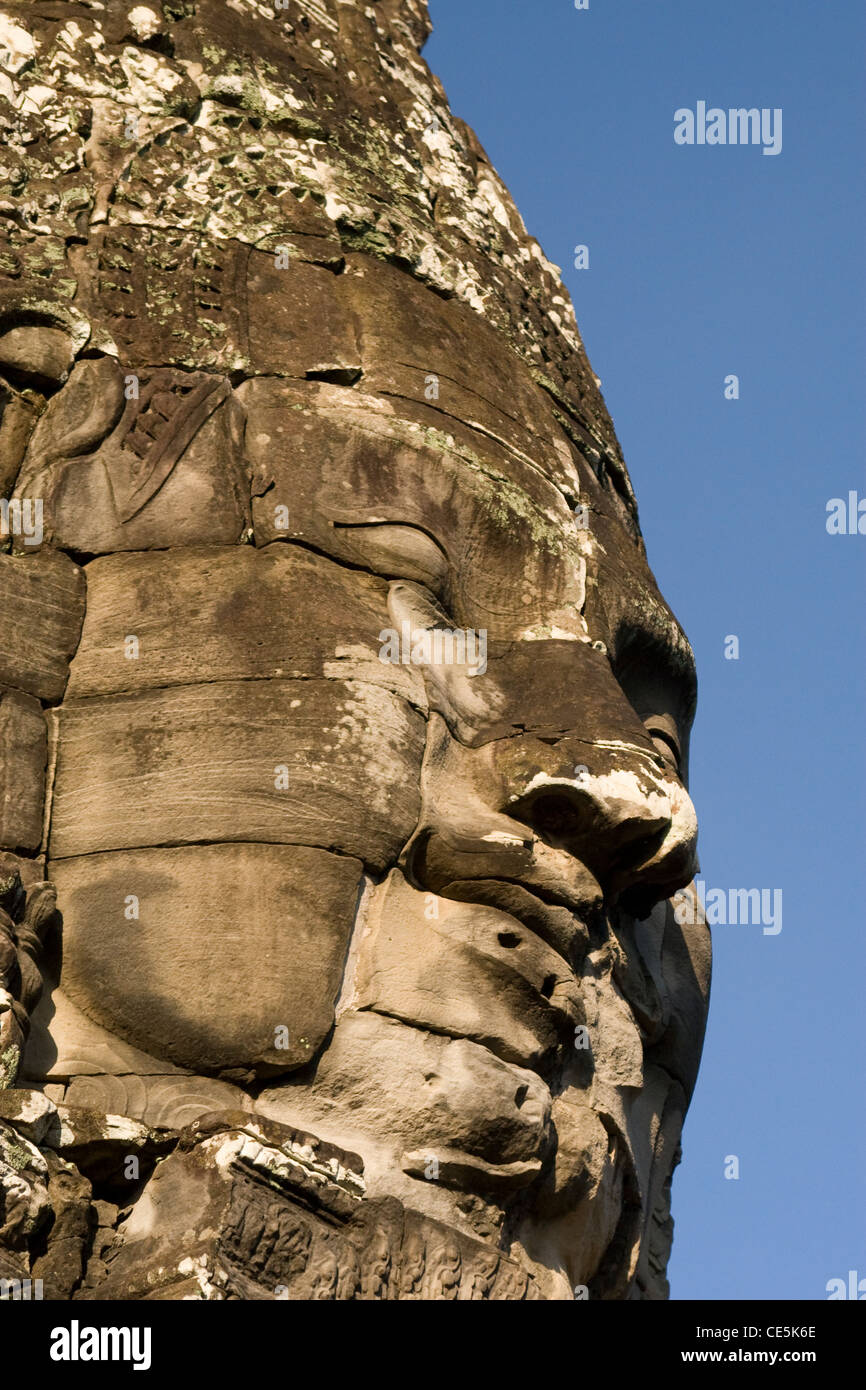 A giant stone face at the temple of Bayon in Angkor, Cambodia. Stock Photo