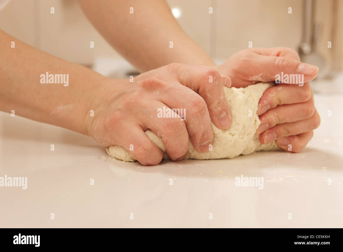 Female cook kneading dough in her kitchen Stock Photo - Alamy