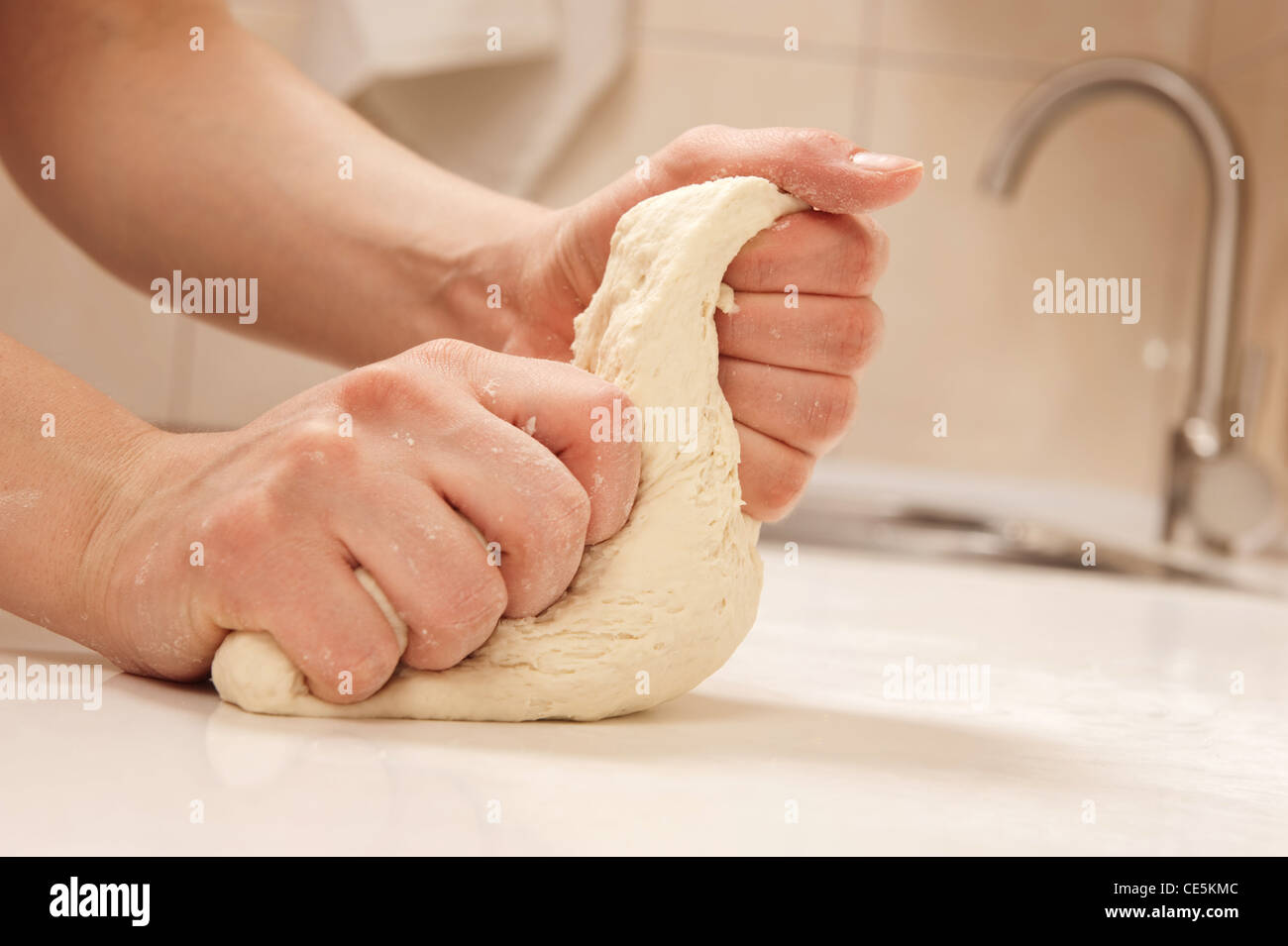 Female cook kneading dough in her kitchen Stock Photo - Alamy