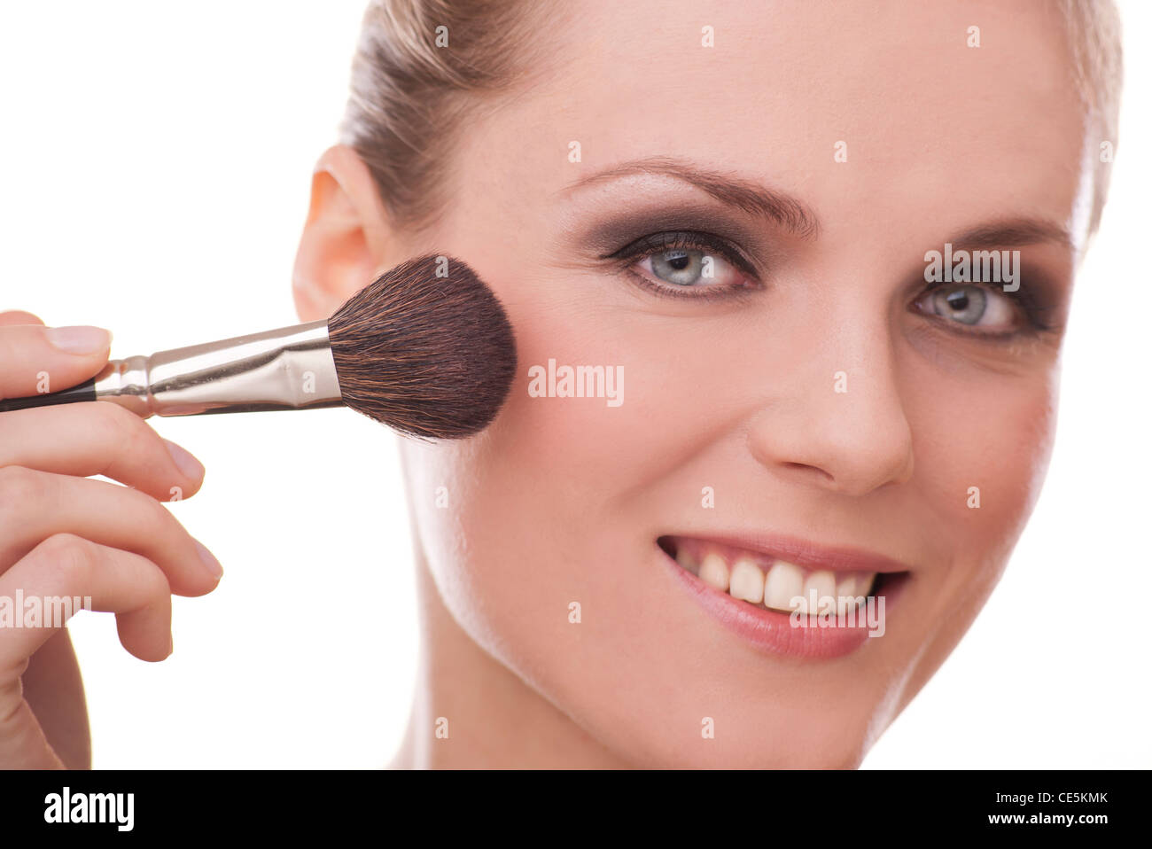 woman applying blush with a blusher brush make up Stock Photo