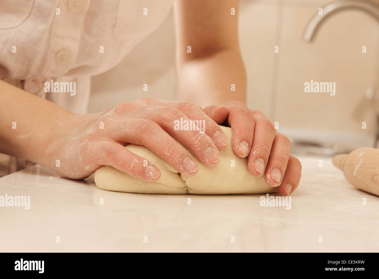 Female cook kneading dough in her kitchen Stock Photo - Alamy