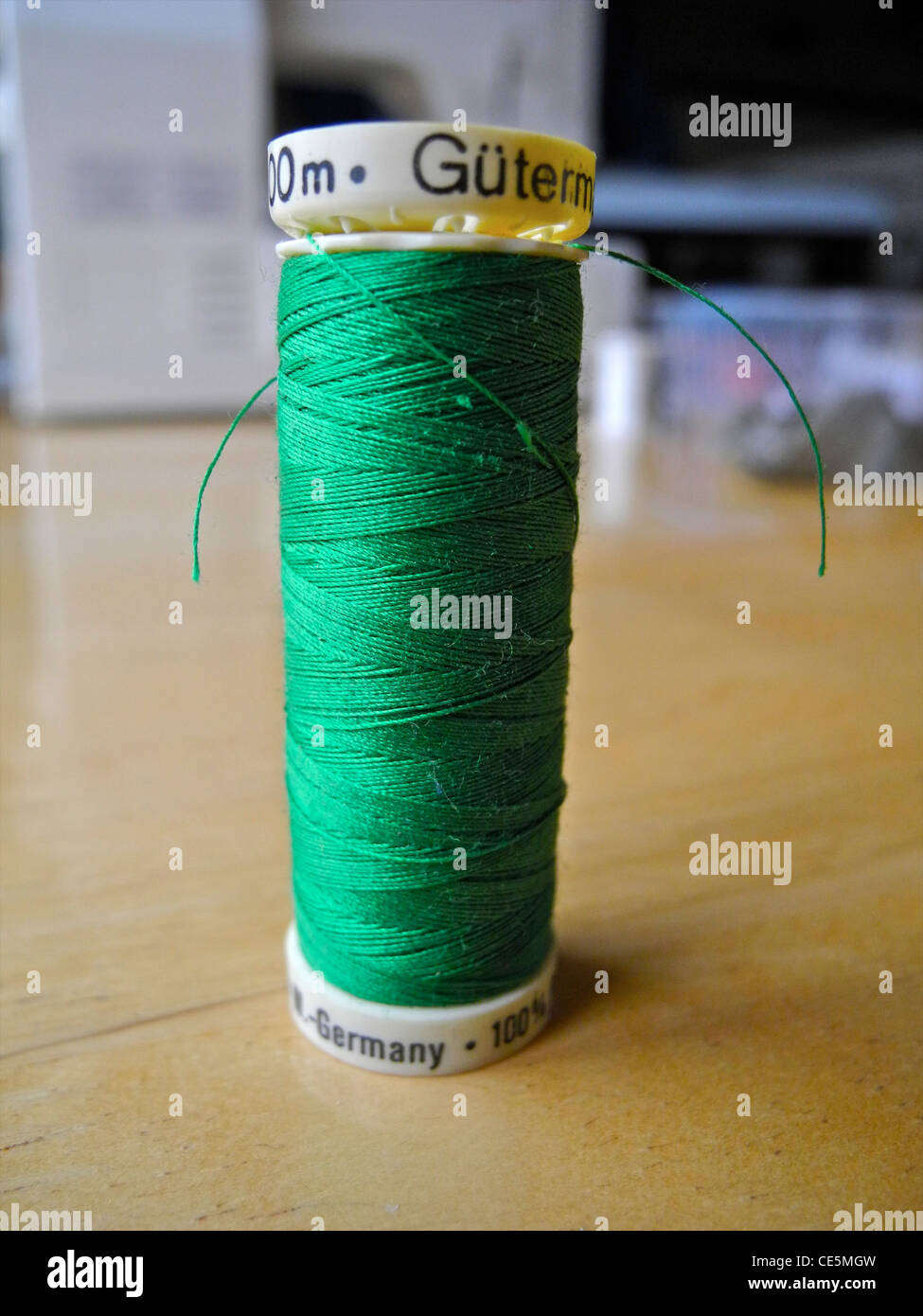 green cotton thread on spool reel Stock Photo