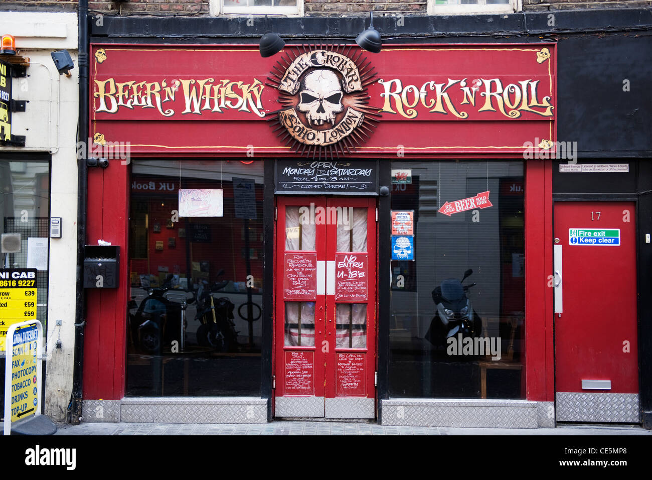 West End Charing Cross Road Soho London The Crobar Beer n Whisky Rock n Roll bar venue signs skull windows doors Manette Street entrance street scene Stock Photo
