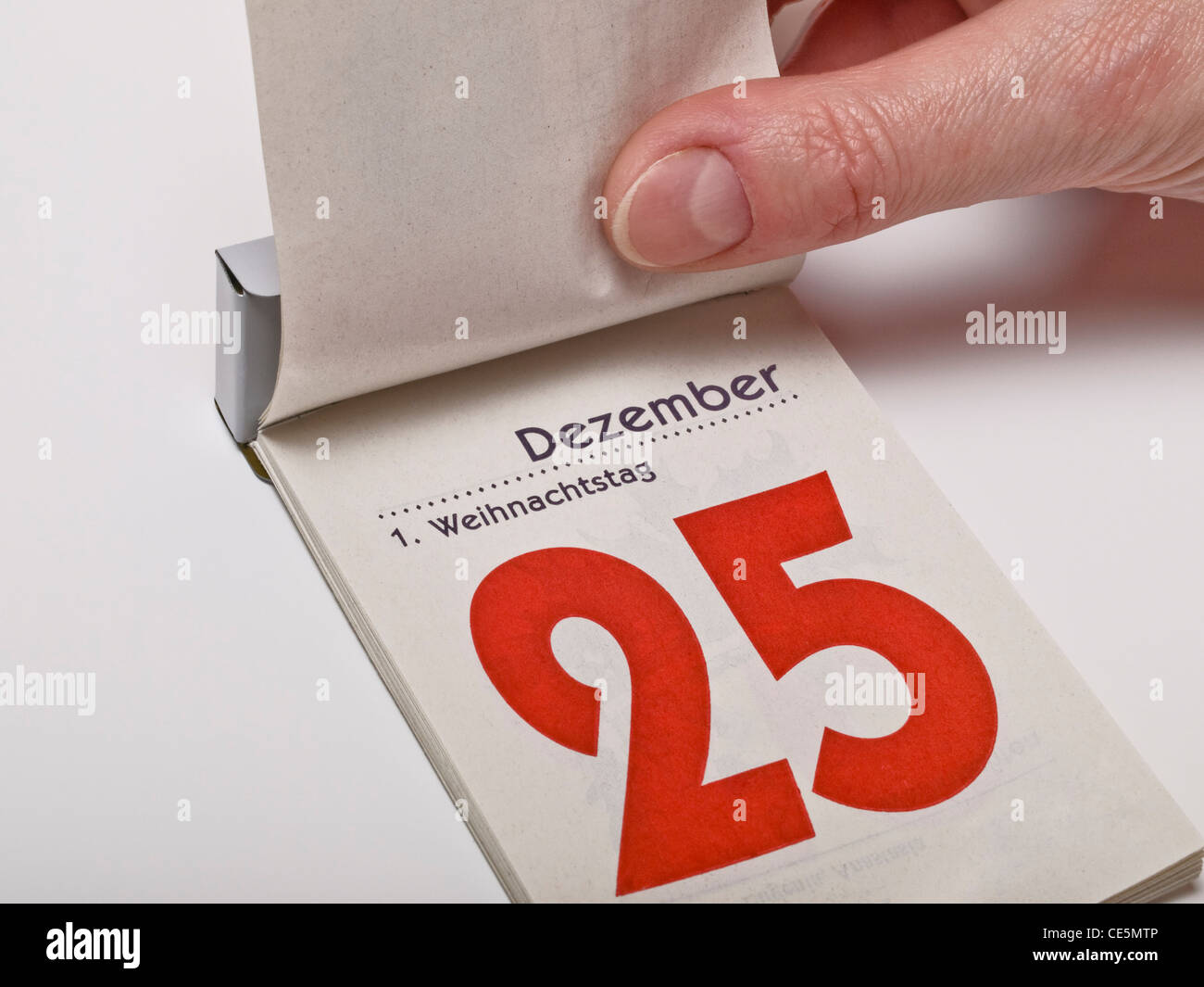 A calendar sheet is lifting and shows December 25th, first Christmas Day Stock Photo