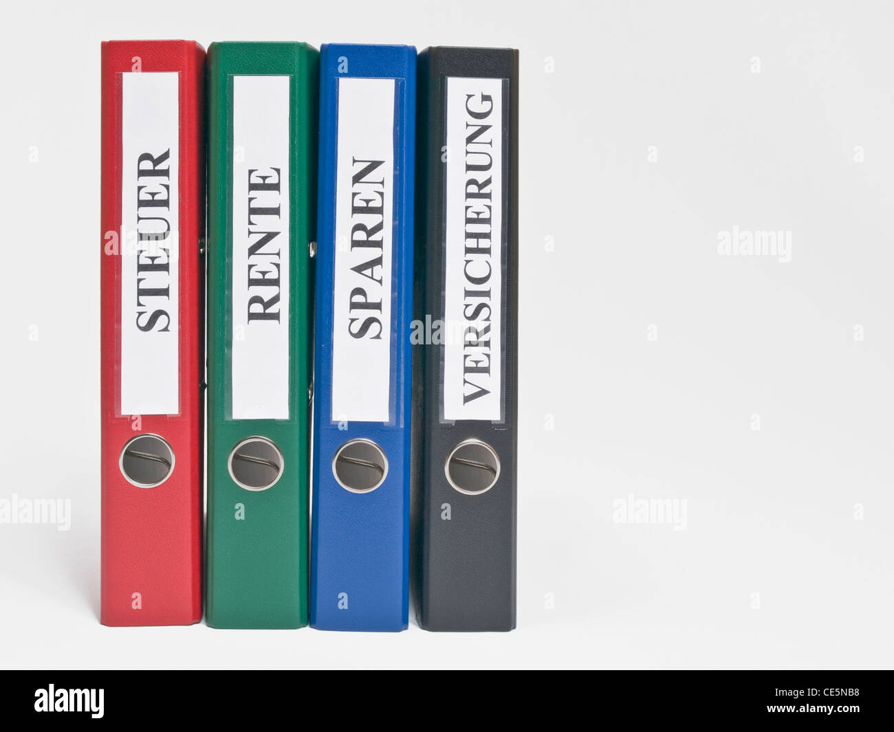 four colored files upright with the German label 'Steuer', 'Rente', 'Sparen' und 'Versicherung'(Tax, Pension, Saving, Insurance) Stock Photo
