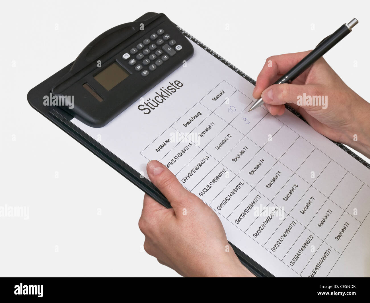 a clipboard with an object list is hold in hands Stock Photo