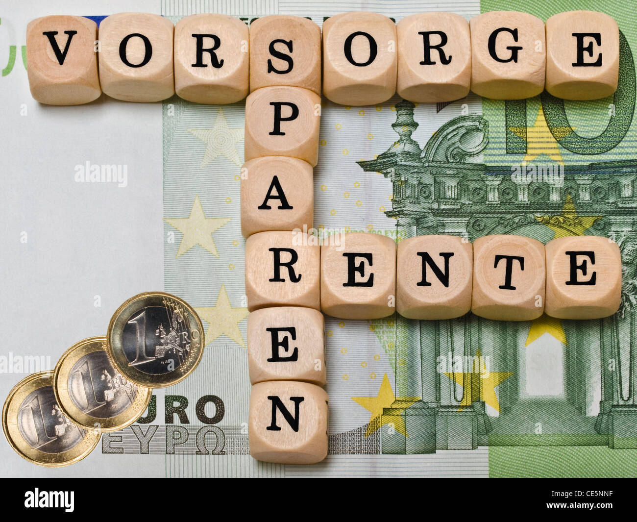 a 100 Euro Banknote, on it are cubes that form the words 'Provision', 'Saving' and 'Pension' in German Stock Photo