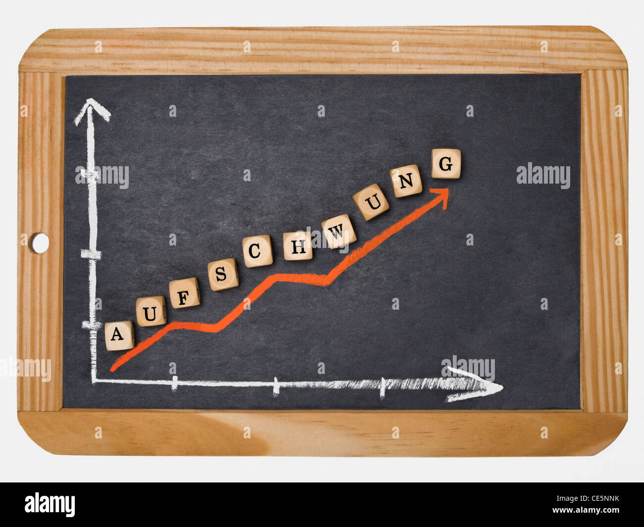 Detail photo of a slate, a chart with an increasing curve on this, alongside are cubes that form the word "Boom" in German Stock Photo