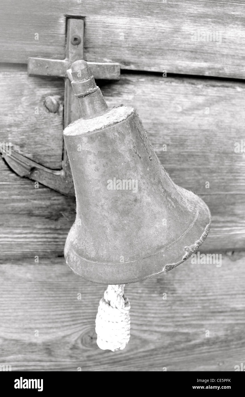Black and white photo of a lonely brass bell. Stock Photo